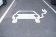 white electric vehicle sign painted on asphalt, charging station, Power Charger ev in Europe, alternative energy, technology and innovation