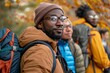 © Vera - Group of African American and Brazilian people in academic achievement team posing in the forest during autumn success education year