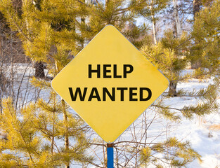 Wall Mural - Help wanted and support symbol. Concept words Help wanted on beautiful yellow road sign. Beautiful forest snow blue sky background. Business, support, help wanted concept. Copy space.