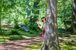 Woman walking in the forest and posing for photos in dappled light. Seattle. USA.