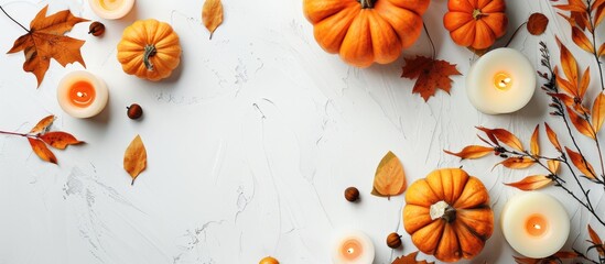 Canvas Print - Fall arrangement featuring pumpkins, candles, and dried leaves set against a white backdrop. Representing autumn, fall, and Halloween themes. Image taken from above with space for text.