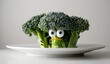 Playful broccoli character on white plate with googly eyes