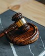 © ParinApril - Closeup of a gavel on polished wood, the grain emphasizing the weight of authority and judgement in legal proceedings