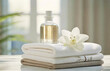 Aromatheraphy, body care, relaxation and wellness design with white towels, flowers and scented oil. Spa treatment products background.