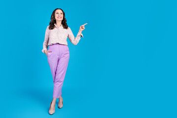 Sticker - Full length photo of attractive senior woman point look empty space dressed stylish formalwear clothes isolated on blue color background