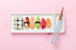 Sushi plate adorned with cherry blossom branch and chopsticks, epitomizing Japanese food culture