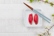 Tuna sushi adorned with cherry blossom branch and chopsticks, epitomizing Japanese food culture
