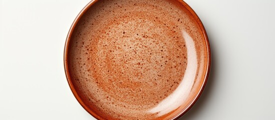 Poster - A ceramic plate with a brown circle set on a white background is devoid of any objects with additional space for text or images