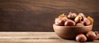 © vxnaghiyev - A copy space image showcasing a bowl of fresh chestnuts placed on a rustic old wooden backdrop