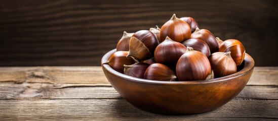 Poster - A copy space image showcasing a bowl of fresh chestnuts placed on a rustic old wooden backdrop
