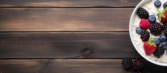 Poster - A breakfast bowl of yogurt oatmeal blueberries blackberries and chia seeds is beautifully displayed on a rustic wooden surface in a top down view leaving ample room for text or a caption in the copy