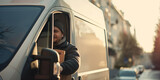 Fototapeta  - A image of a delivery driver driving a delivery van or truck, making stops along their route to drop off packages and parcels