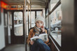 Young Boy Engrossed in Reading While Riding the City Bus, Immersed in a Book