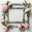 A frame with pink flowers and leaves surrounding it