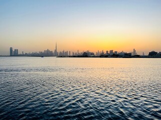 Wall Mural - City river at the sunset time, silhouette of the cityscape at the river, twilights