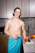 A young attractive guy in the kitchen is preparing a healthy lunch.