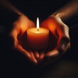 © Anna - Hands holding a candle on the dark background