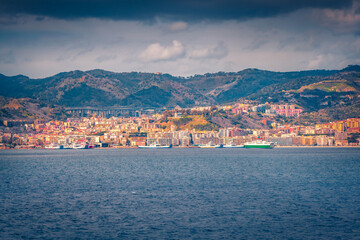 Wall Mural - Dramatic morning cityscape of Messina port with old colorful buildings, Sicily, Italy, Europe. Wonderful summer seascape of Mediterranean sea. Traveling concept background.