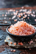 Pink himalayan salt in bowl on wooden table