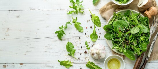 Wall Mural - Fresh green salad ingredients suitable for spring season and kitchen utensils on a white wooden surface, seen from above with space for text.