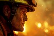 This impactful image captures a close-up of a firefighter's face, deeply focused and illuminated by the intense, glowing sparks of a fire behind him during a nighttime operation.