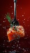 A forkful of salmon with rosemary and pink peppercorns