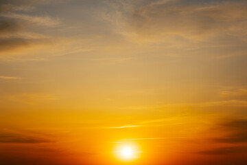 Wall Mural - majestic dusk. beautiful warm blue sky with vivid golden shades. dense clouds in twilight orange sky
