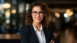 © Molang Visual - Portrait of a smiling young businesswoman wearing glasses
