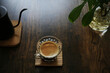 coffee in a glass cup on dark brown wooden table