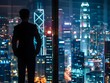 © ITrWorks - businessman standing with view of buildings at night