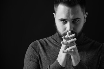 Wall Mural - Portrait of handsome bearded man on dark background. Black and white effect