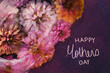 Happy Mothers day greeting handwriting for holiday background with zinnia flowers in ice.