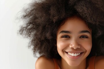 Wall Mural - A woman with a big afro smiling at the camera. Suitable for various projects