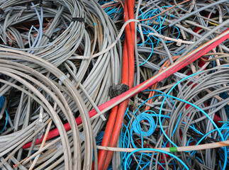 Sticker - background of old electrical cords in landfill for recycling copper and plastic