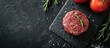Organic minced beef burger steak served on a slate board, representing healthy food within the context of a cooking blog or culinary classes. Top view with space for text.