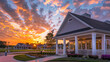 © Zara - Sunset beautifully casting warm hues on a new clubhouse with a white porch and gable roof, captured in high definition.