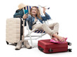 Tourist woman in travel attire, on deck chair with trolley suitcases, show a model airplane, using mobile phone. Summer beach holiday, flight and vacation travel booking. Travel influencer lifestyle