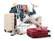 Tourist woman in travel attire, on deck chair with trolley suitcases, show a model airplane, using mobile phone. Summer beach holiday, flight and vacation travel booking. Travel influencer lifestyle