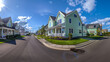 Panoramic angle capturing the entire street, with a standout seafoam green house with siding at its heart, epitomizing suburban harmony.