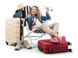 Tourist woman in travel attire, on deck chair with trolley suitcases, show mobile phone screen and model airplane. Summer beach holiday, flight and vacation travel booking. Travel influencer lifestyle