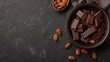 © Otseira - chocolate with almonds on dark grey background with copy space