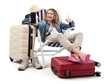 Tourist woman in travel attire, on deck chair with trolley suitcases, showing mobile phone screen and thumbs-up. Summer beach holiday, flight and vacation travel booking. Travel influencer lifestyle