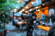 © ivlianna - Group discussion among industry experts on sustainable economic growth strategies .A camera on a tripod in a restaurant, ready for the videographer