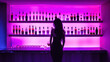Violet bottles of alcohol in bar and woman's silhouette
