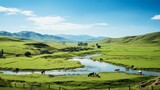 Cows grazing in a lush green field near a river in the countryside