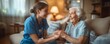 © gearstd - Caring nurse holds elderly woman's hand