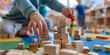 toddlers hands building tower with natural child plays with wooden blocks on a table Top view of interior preschool close up of a toddler building a tower with wooden blocks and playing games with mon