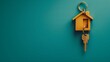 © Anastasia Knyazeva - Golden house shaped keychain with keys on blue background, real estate concept, top view. Copy space banner mockup stock photo with copy space for text.