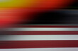 Abstract blurred background, horizontal black, orange, white, red stripes.