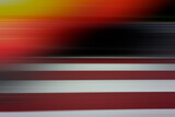 Fototapeta Tęcza - Abstract blurred background, horizontal black, orange, white, red stripes.